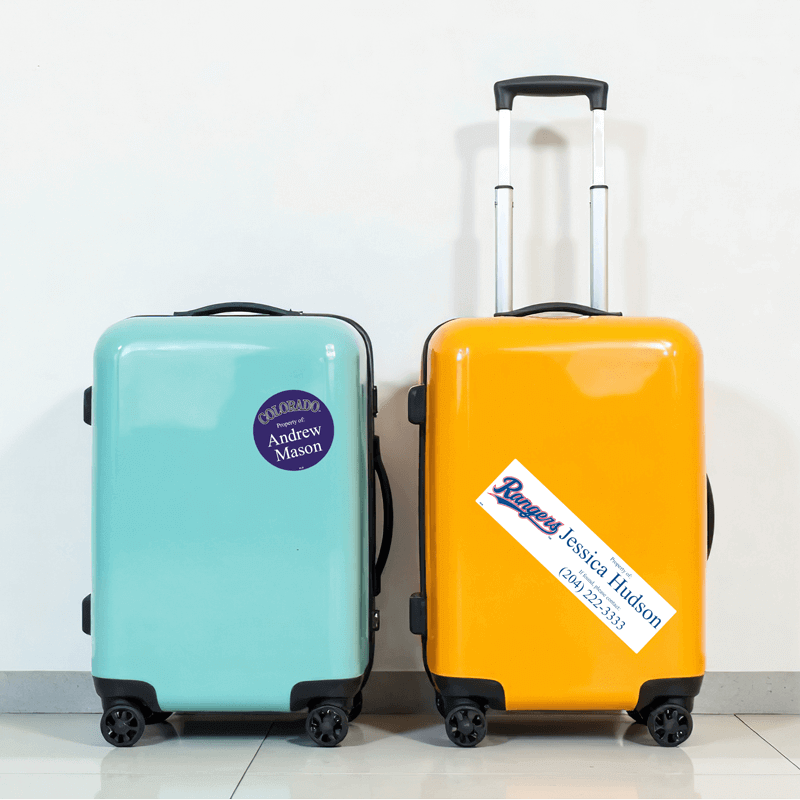 Luggage tags on two pieces of luggage.