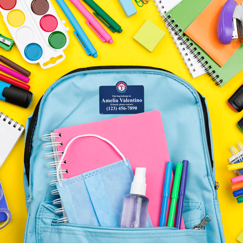 Bag tag on backpack with school supplies.