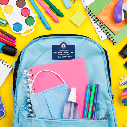 Bag tag on backpack with school supplies.